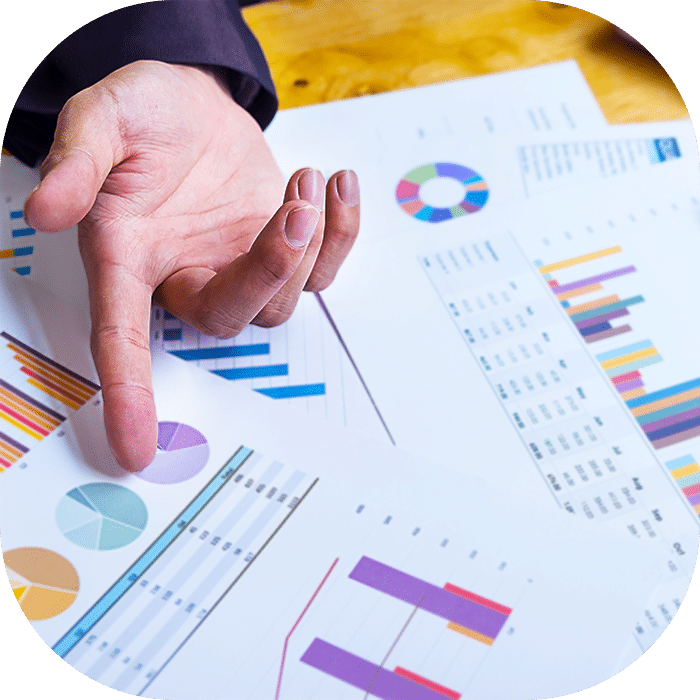 Main pointant un graphique présentant les résultats d’une étude consommateurs
