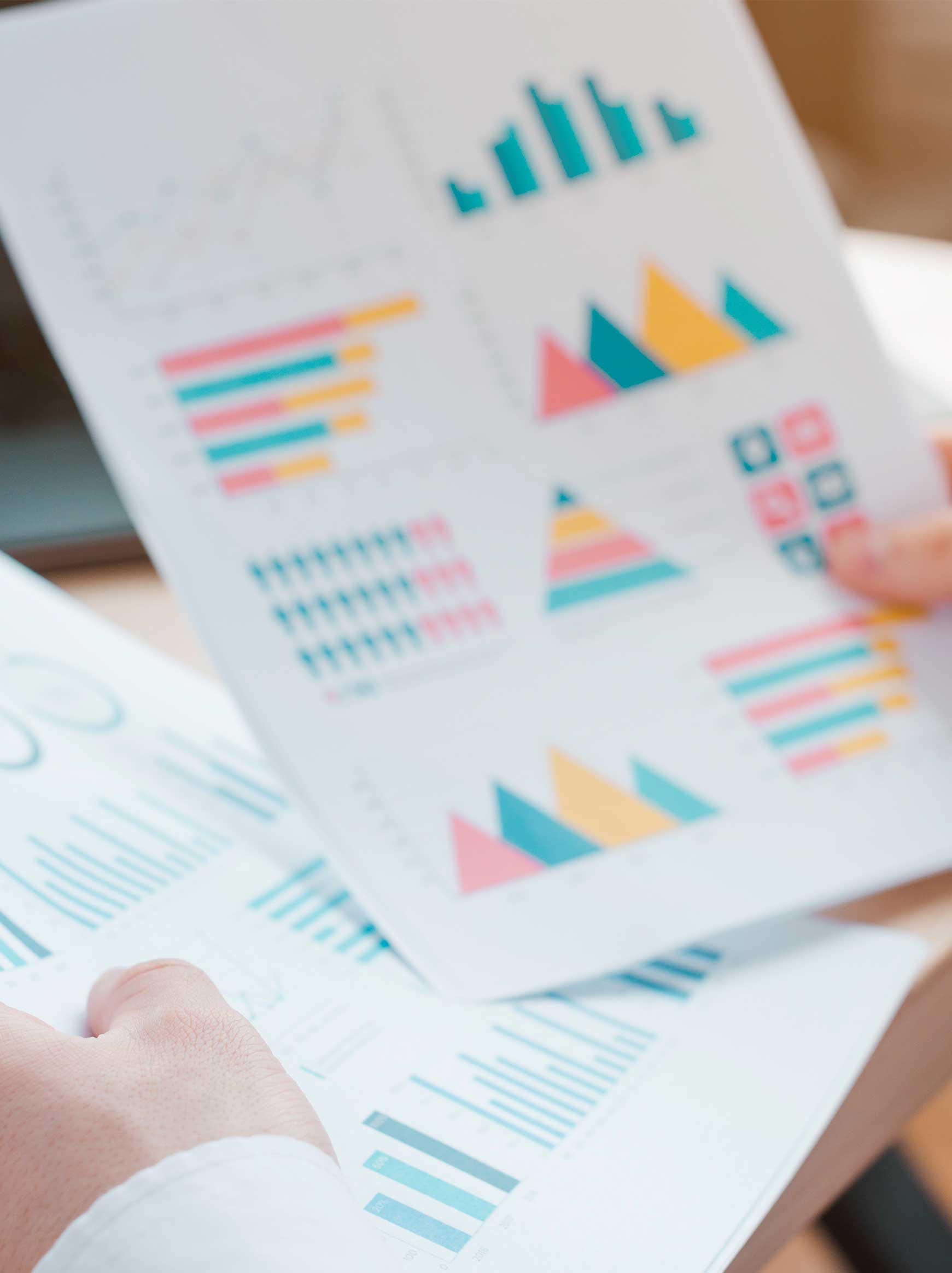 Hands of a person reviewing a quantitative study report.