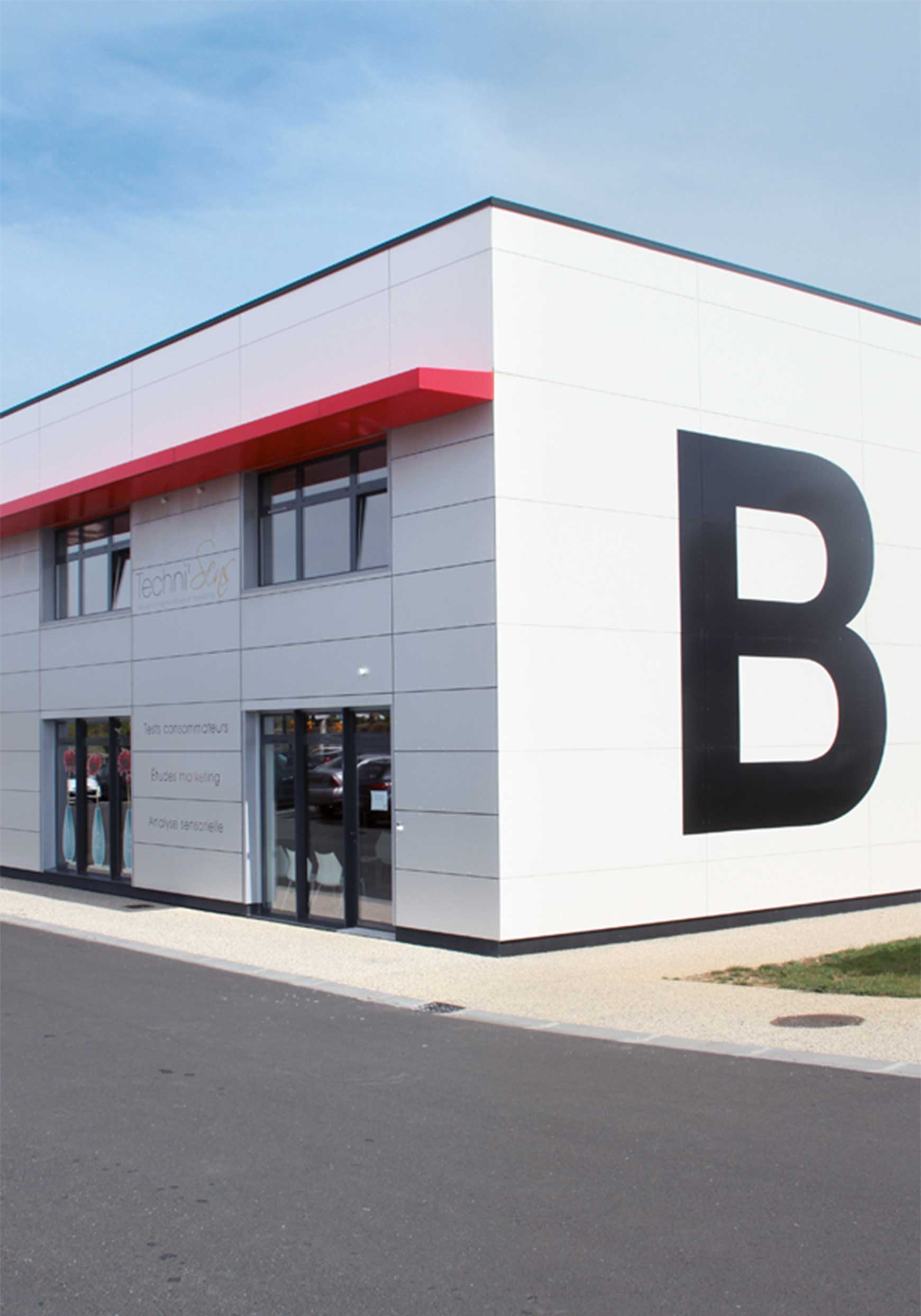 Front view of Techni'Sens headquarters in La Rochelle, a modern building with the company logo.